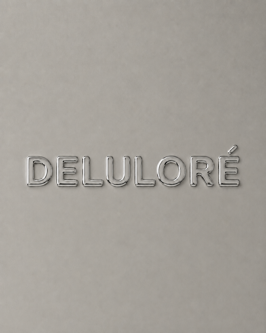 The Deluloré wordmark rendered in polished chrome